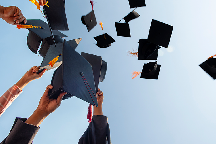 Graduates throwing their caps in the air.